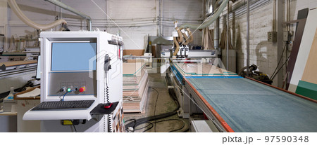 Blue screen system control cabinet with keyboard and mouse in industrial factory producing wooden furniture parts. 97590348