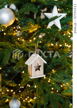 Wall texture decorated with garlands and green pine spruce branches and toys, christmas decorations background Wall texture decorated with garlands and green pine spruce branches and toys, christmas decorations background 97591013