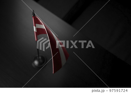 Small national flag of the Latvia on a black background Small national flag of the Latvia on a black background 97591724