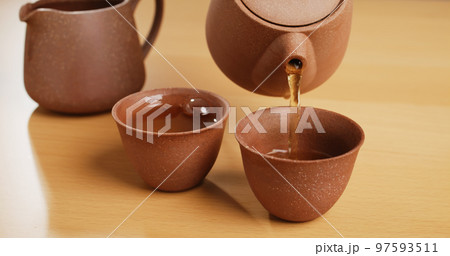 Traditional Chinese tea ceremony, pour tea into a cup Traditional Chinese tea ceremony, pour tea into a cup 97593511