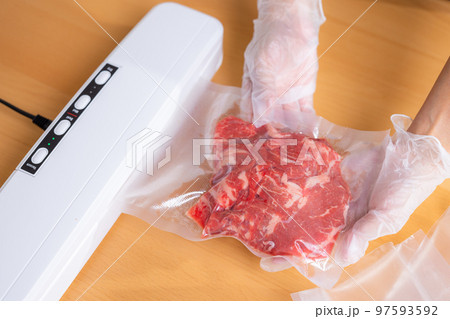 Raw beef meat sealed in plastic shrink wrap with vacuum sealer Raw beef meat sealed in plastic shrink wrap with vacuum sealer 97593592