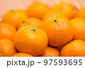 Stack of citrus fruit on basket 97593695