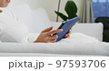 Woman hold with tablet computer and sit on sofa at home 97593706