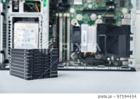 Closed-up view of SSD hard disk drives with PC in the background Closed-up view of SSD hard disk drives with PC in the background 97594434