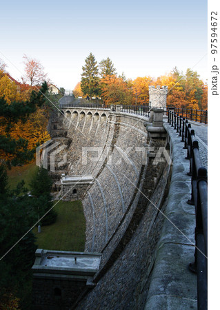 Stone dam in the autumn landscape 97594672