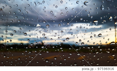 Rain water drops cover on the glass with blur background 97596916