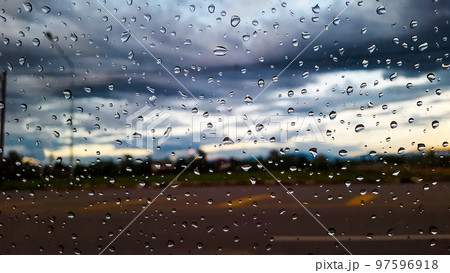 Rain water drops cover on the glass with blur background 97596918