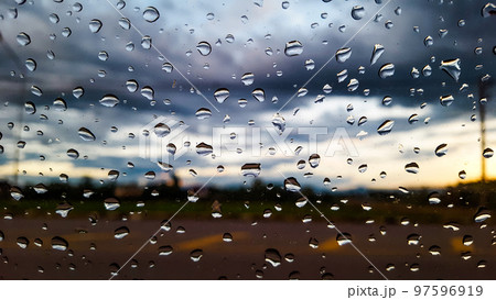 Rain water drops cover on the glass with blur background 97596919