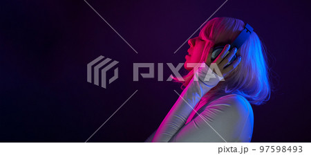 Woman in headphones listening music and enjoing Woman in headphones listening music and enjoing 97598493