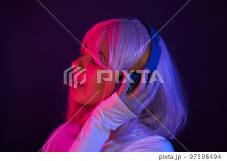 Woman in headphones listening music and enjoing 97598494