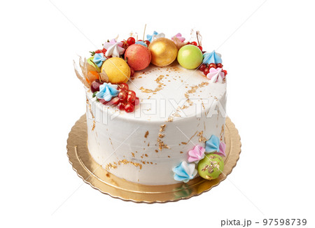 Celebration cake with gold. Decoration of fruit macaroon meringue. On a white background. Close-up. Celebration cake with gold. Decoration of fruit macaroon meringue. On a white background. Close-up. 97598739