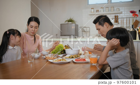 Family concept of 4k Resolution. Asian parents and children eating together in the house. 97600101