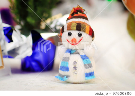 cheerful snowman and Christmas decorations on the Christmas table cheerful snowman and Christmas decorations on the Christmas table 97600300