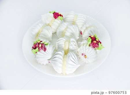 Delicious bizet marshmallows on a white plate. A sweet snack. Marshmallows for tea. 97600753