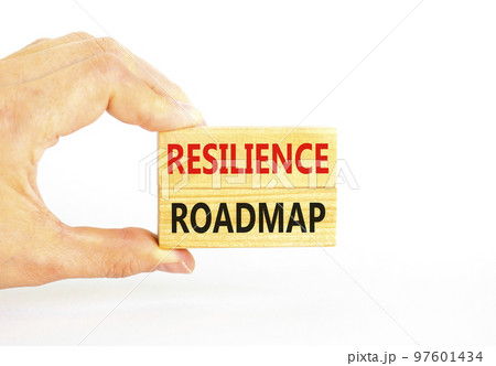 Resilience roadmap symbol. Concept word Resilience roadmap typed on wooden blocks. Beautiful white table white background. Businessman hand. Business and resilience roadmap concept. Copy space. 97601434