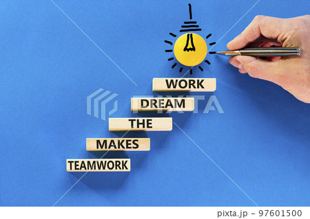 Teamwork makes dream work symbol. Concept words Teamwork makes the dream work on wooden blocks on a beautiful blue background. Businessman hand. Business Teamwork makes dream work concept. Copy space. 97601500