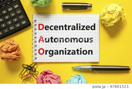 DAO decentralized autonomous organization symbol. Concept words DAO decentralized autonomous organization on white note on a beautiful yellow background. Business and DAO concept. Copy space. DAO decentralized autonomous organization symbol. Concept words DAO decentralized autonomous organization on white note on a beautiful yellow background. Business and DAO concept. Copy space. 97601523