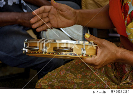 Percussionist hands playing tambourine during brazilian carnival Percussionist hands playing tambourine during brazilian carnival 97602284