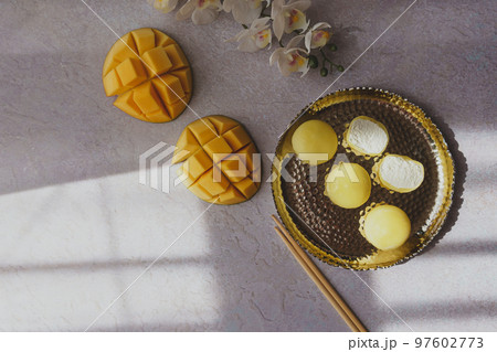 Tasty dessert Mochi with mango fruit on grey background Tasty dessert Mochi with mango fruit on grey background 97602773