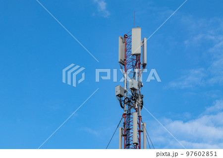 Mobile or cell tower with antennas on blue sky 97602851