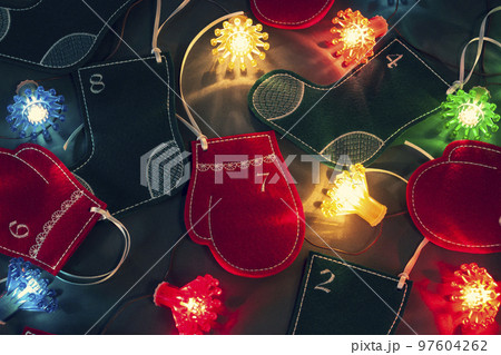 Felt stockings, mittens and fairy lights as beautiful Christmas home decoration. Advent calendar for kids 97604262