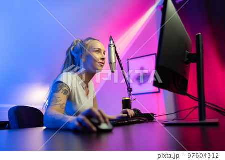 Beautiful professional gamer girl streams and play online multiplayer video game on PC Beautiful professional gamer girl streams and play online multiplayer video game on PC 97604312
