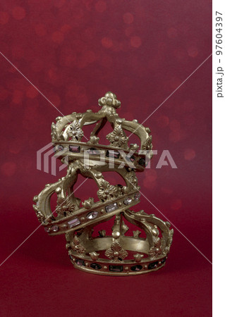 Happy Three King's Day. Three gold crowns on red background. Concept for Reyes Magos, Three Wise Men or Happy Epiphany day. 97604397