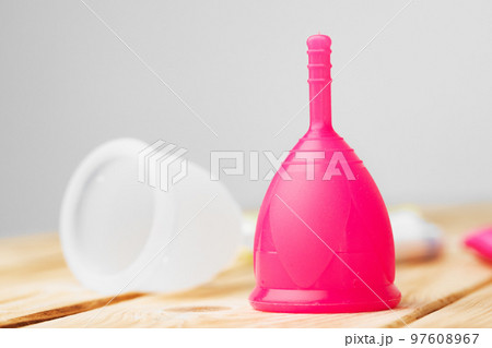 Two menstrual cups on table close up Two menstrual cups on table close up 97608967