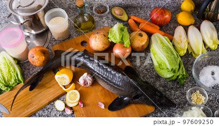 Raw uncooked fish sturgeon at plate with vegetable Raw uncooked fish sturgeon at plate with vegetable 97609250