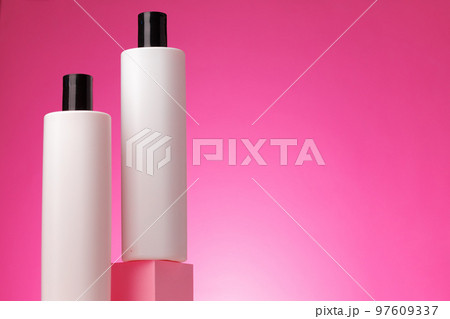 Blank white cosmetic container against pink background 97609337