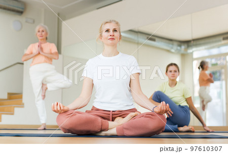 Woman practice yoga lotus pose 97610307