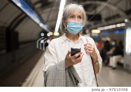 Mature woman in protective mask in metro station 97610308