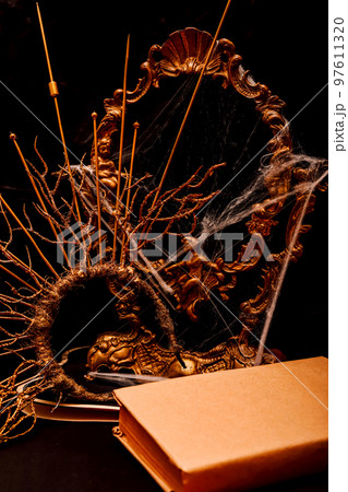 Halloween book composition, spider web, old vintage frame on a black background 97611320