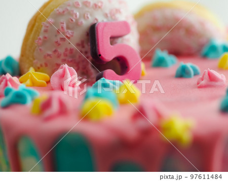 pink 5th anniversary birthday frosted icing dripping cake on white background pink 5th anniversary birthday frosted icing dripping cake on white background 97611484