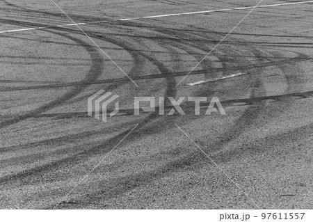 Tire tracks texture and background, Asphalt texture with line and tire marks, Automobile automotive tire skid mark on race track, Abstract texture car drift tire skid mark. 97611557