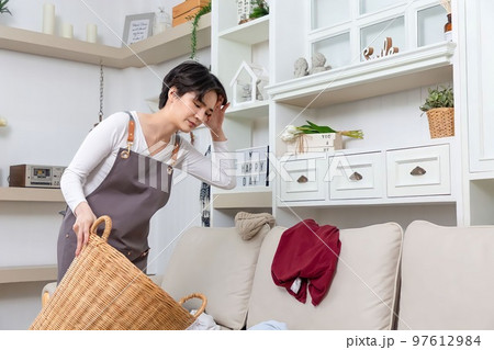 Happy Asian cleaner woman with laundry working at home. Happy Asian cleaner woman with laundry working at home. 97612984