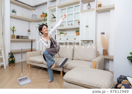 Happy asian woman holding with mop cleaning floor and singing at home. Housekeeping concept Happy asian woman holding with mop cleaning floor and singing at home. Housekeeping concept 97612989
