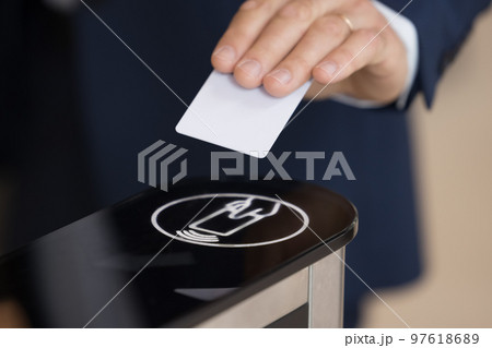 Unknown businessman in formal suit uses pass card passing checkpoint 97618689