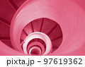 Old stairs in spiral staircase toned in Color of year 2023. Viva magenta. 97619362