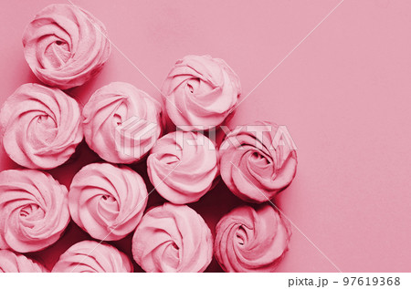 Colorful marshmallows on magenta background. Color of year 2023. Viva magenta. Color sweet homemade zephyr Colorful marshmallows on magenta background. Color of year 2023. Viva magenta. Color sweet homemade zephyr 97619368
