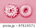 Color of year 2023. Viva Magenta. Two donuts with icing on pastel background. Copyspace 97619371
