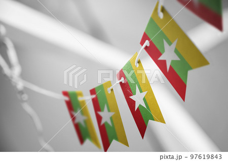 A garland of Myanmar national flags on an abstract blurred background 97619843
