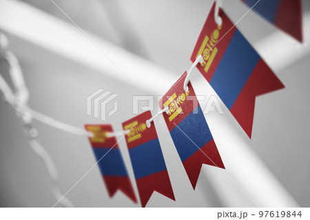 A garland of Mongolia national flags on an abstract blurred background 97619844