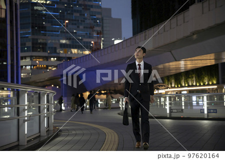 夜の街を歩くスーツ姿のビジネスマン 97620164
