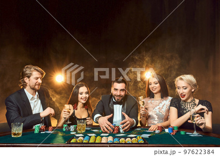 Poker players sitting around a table at a casino. 97622384