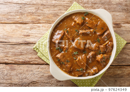 Belgian Carbonnade Beef and Beer Stew closeup in the pot. Horizontal top view 97624349