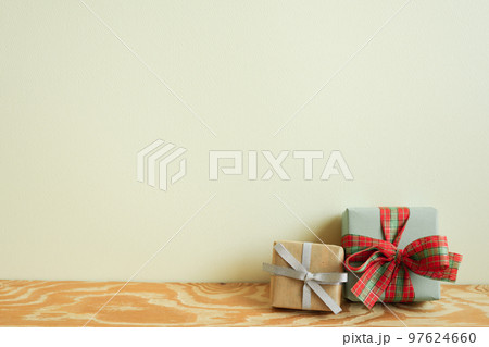 Gift boxes on wooden table. ivory wall background. winter christmas, copy space Gift boxes on wooden table. ivory wall background. winter christmas, copy space 97624660