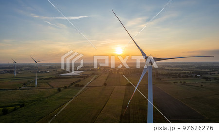Wind farm with wind Turbine in a rural area against the sunset seen from an aerial view shot by a 97626276
