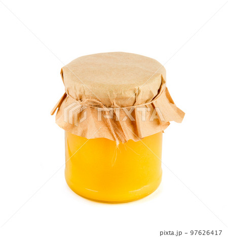 Golden honey in a jar isolated on a white background. 97626417