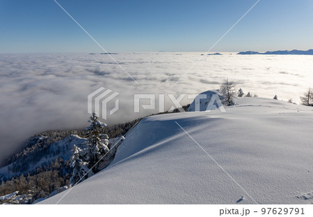 Winter mountains covered with snow landscape over clouds Winter mountains covered with snow landscape over clouds 97629791